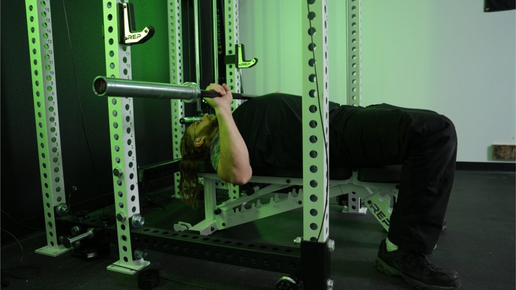 Tester BarBend using the REP Fitness bench for bench press.