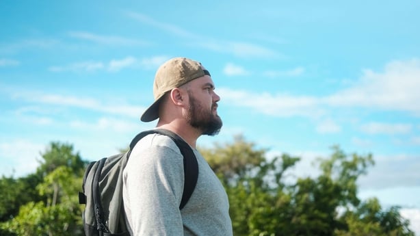 Man walking on a sunny day with a backpack