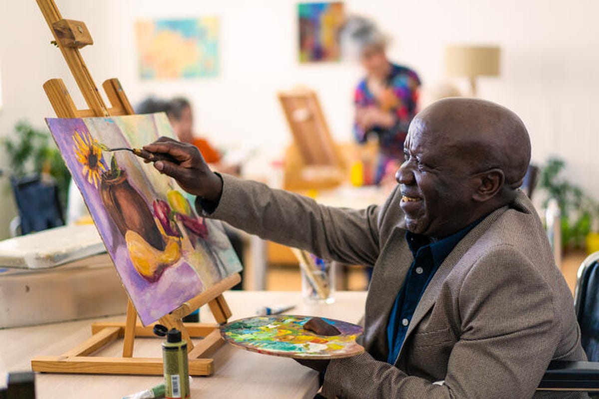 Old man painting a still life