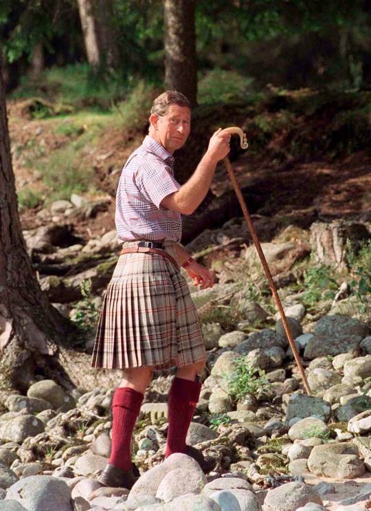 BALMORAL, UNITED KINGDOM - AUGUST 12: Prince Charles in a kilt and with a shepherd's staff at Polvier, Balmoral Castle Estate.  Wear a plaid shirt according to Turnbull and Asser.  (Photo by Tim Graham Photo Library via Getty Images)