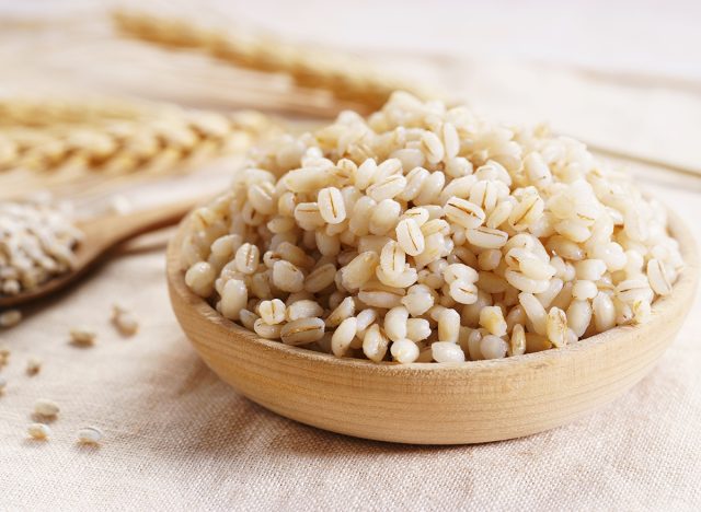 cooked barley in a wooden bowl