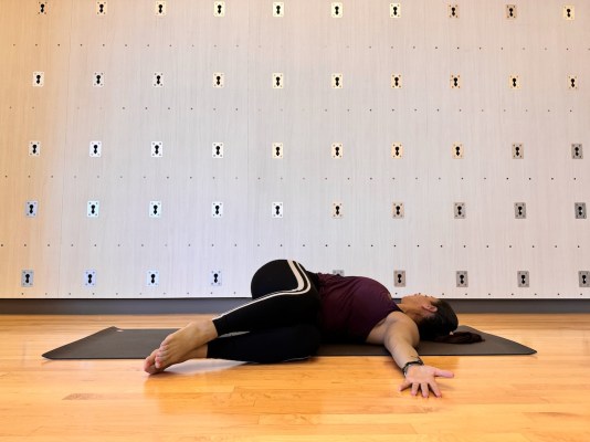 Pilates instructor demonstrating the supine twist 